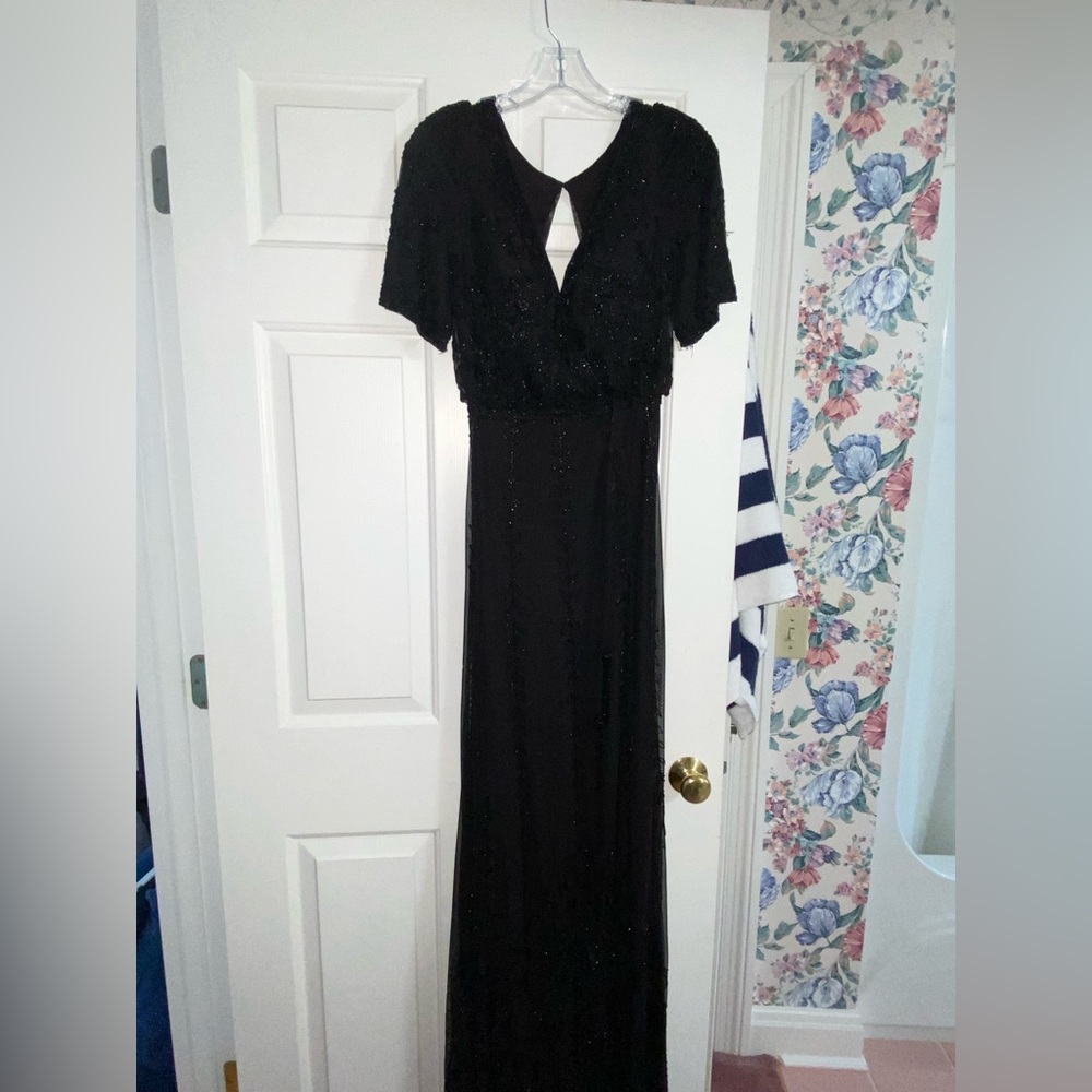 Sheri Hill black short sleeve backless gown. Never before worn. Size 2